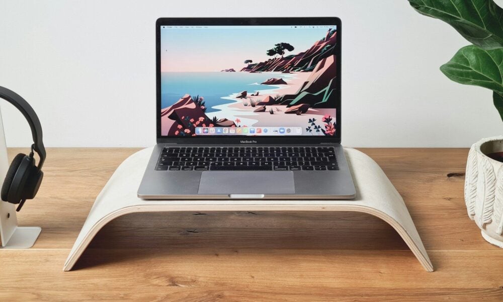 a laptop computer sitting on top of a wooden desk
