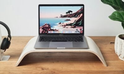 a laptop computer sitting on top of a wooden desk