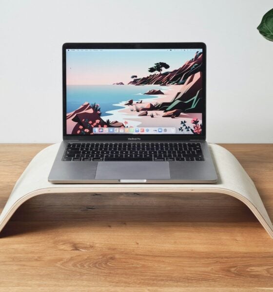 a laptop computer sitting on top of a wooden desk