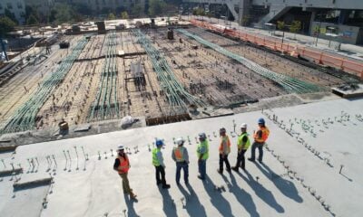 seven construction workers standing on white field