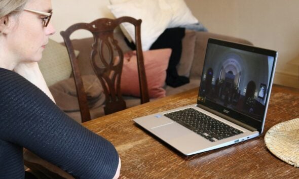 a woman sitting at a table with a laptop
