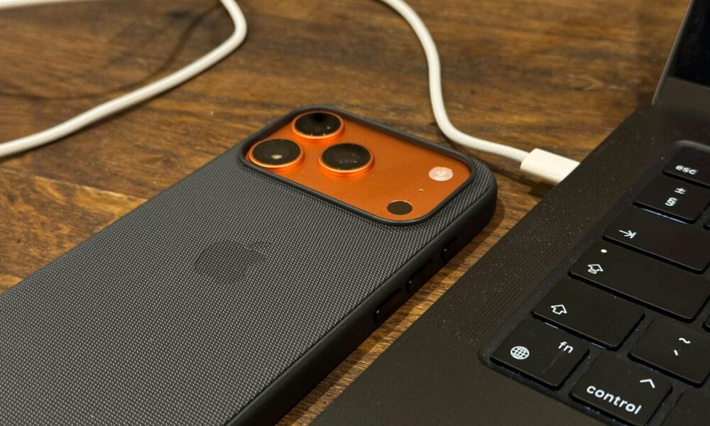 Smartphone connected to a laptop with a cable