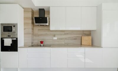Modern white kitchen with wooden accent wall