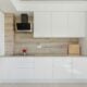 Modern white kitchen with wooden accent wall