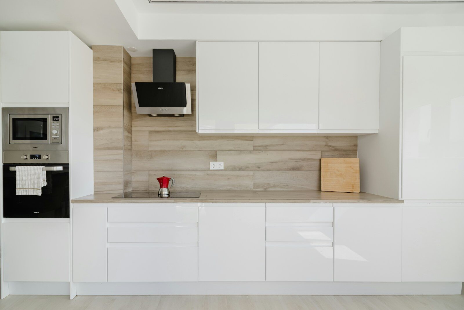 Modern white kitchen with wooden accent wall