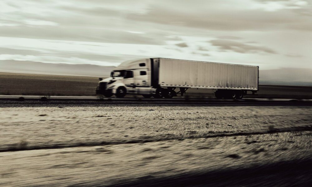 a large semi truck driving down a highway