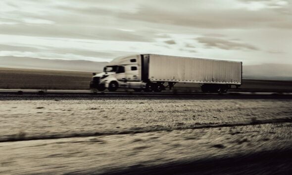 a large semi truck driving down a highway