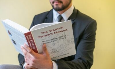a man in a suit is reading a book