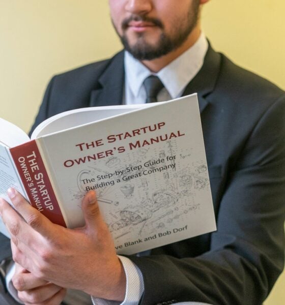 a man in a suit is reading a book