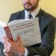a man in a suit is reading a book