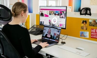 a woman sitting at a desk with a laptop computer