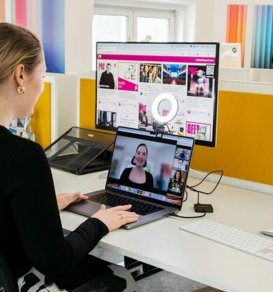 a woman sitting at a desk with a laptop computer