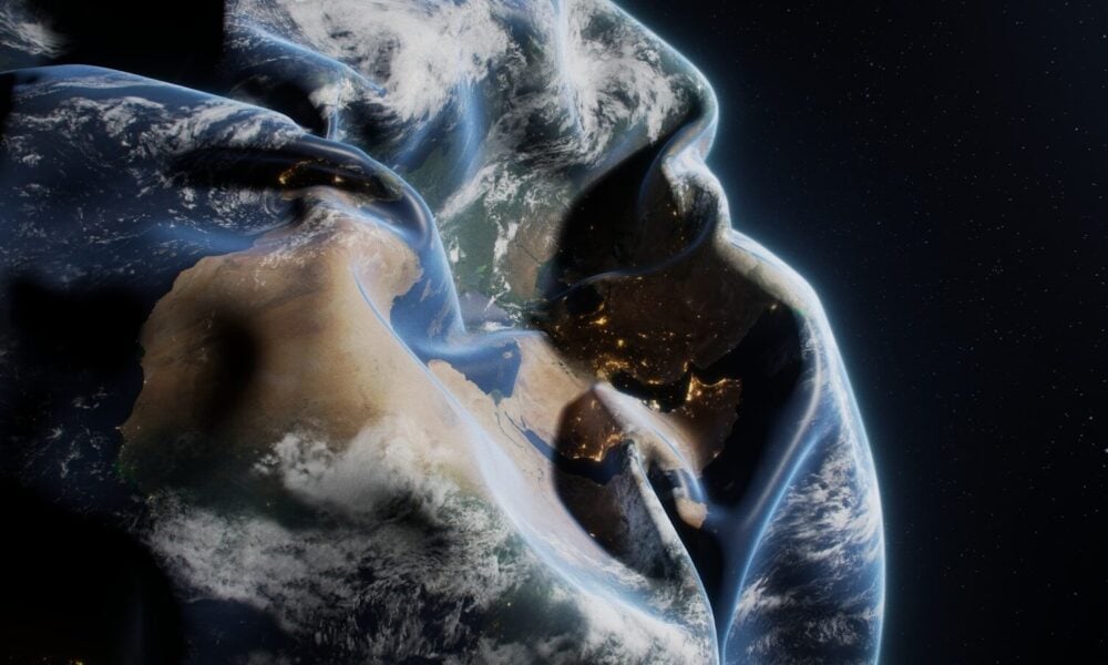 A man in a hoodie with the earth in the background