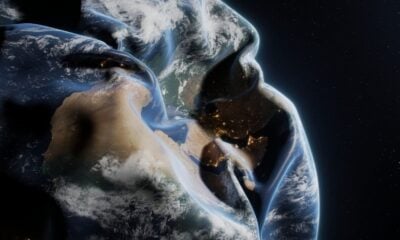 A man in a hoodie with the earth in the background