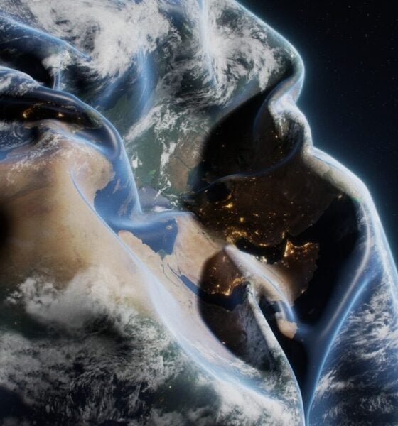 A man in a hoodie with the earth in the background