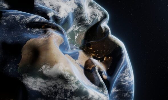 A man in a hoodie with the earth in the background