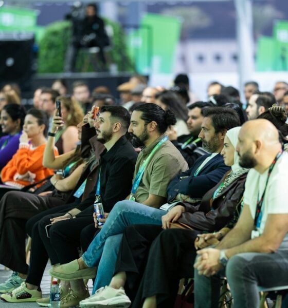 Diverse audience attentively listening at a conference event.