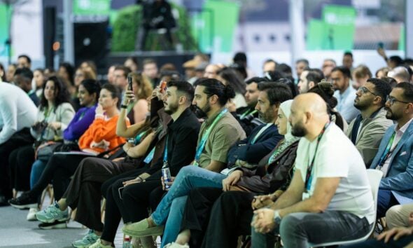 Diverse audience attentively listening at a conference event.