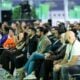Diverse audience attentively listening at a conference event.