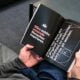 a person is reading a book on the floor