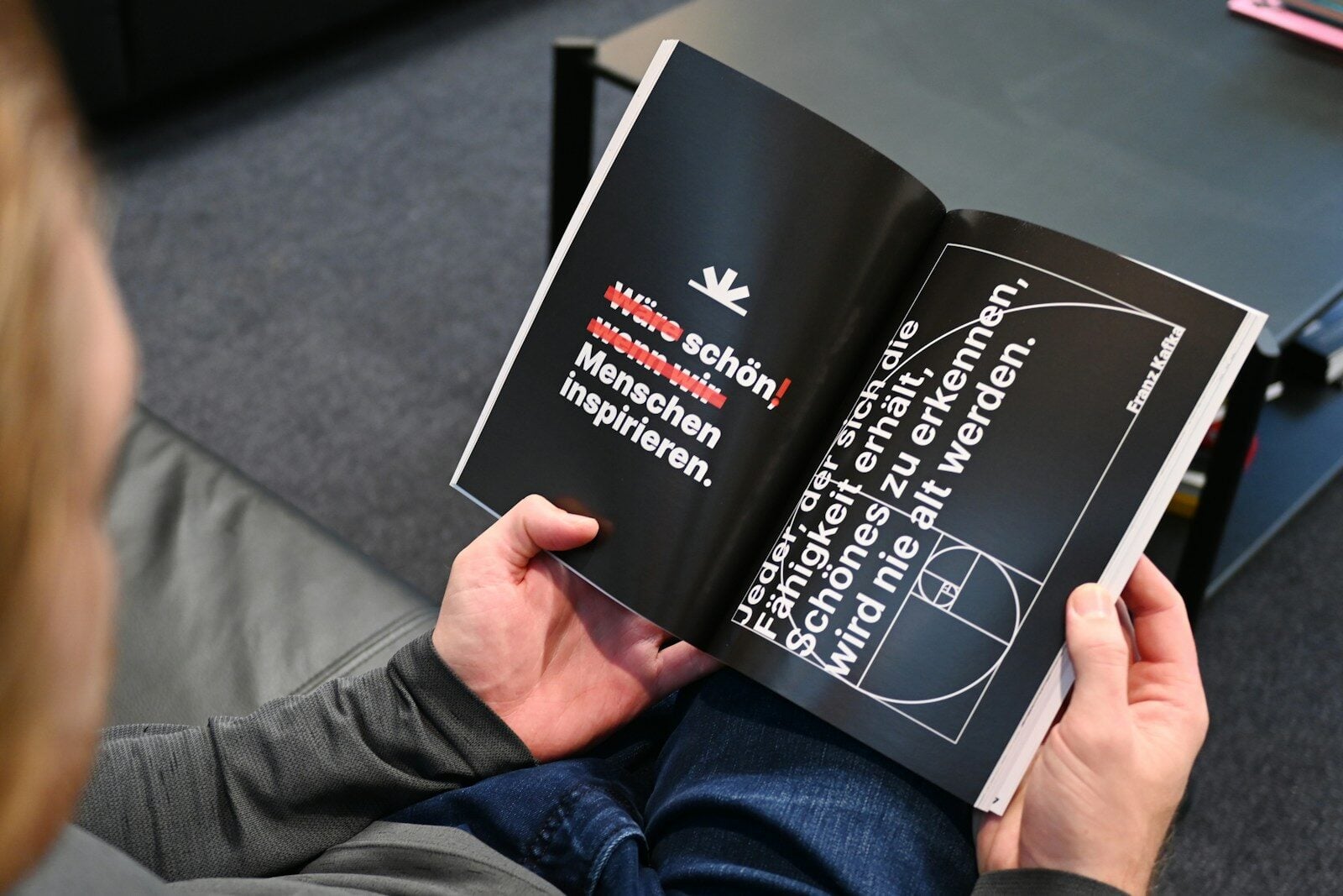 a person is reading a book on the floor