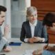 Business people signing a contract at a table.