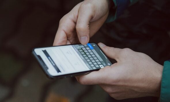 selective focus photography of person using smartphone