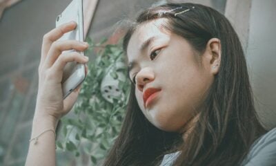 woman holding smartphone outside