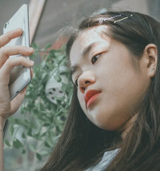 woman holding smartphone outside