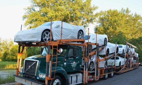 A truck with a car on the back of it