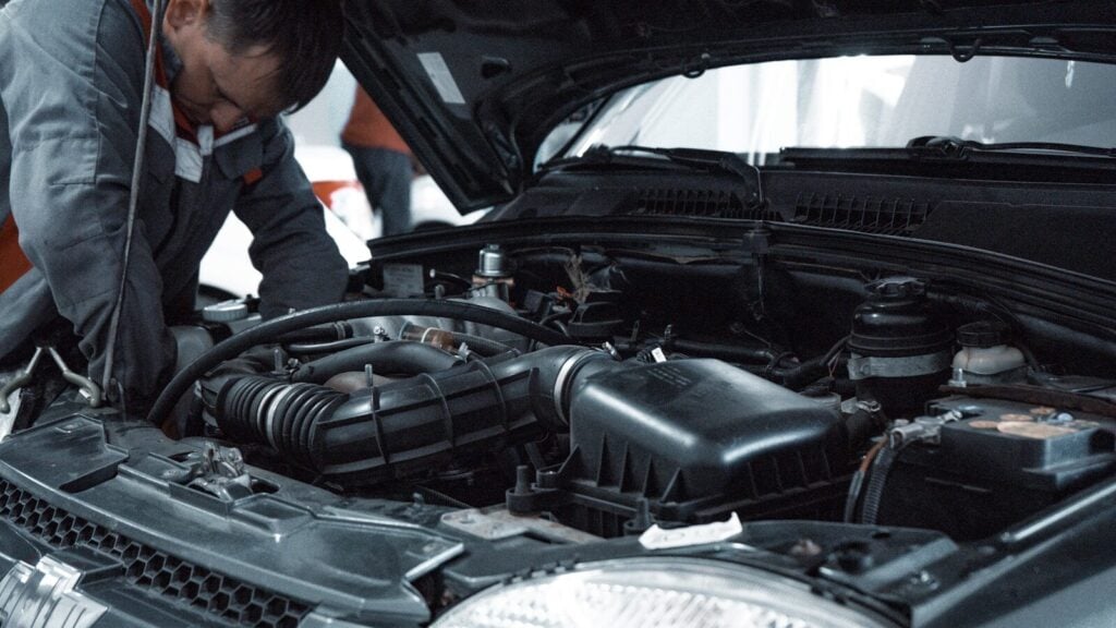 Vehicle Electrical Repair: Common Problems, Costs, and Solutions 27 man in white shirt standing beside black car