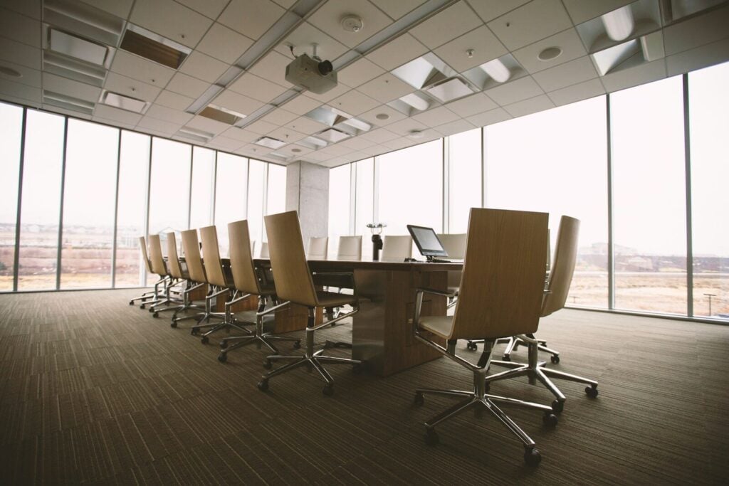 AI Governance Business Context Strategic Visibility: Complete Guide 28 oval brown wooden conference table and chairs inside conference room