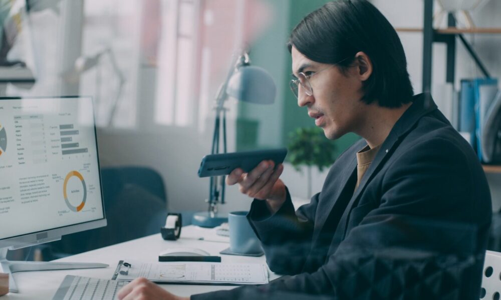 A woman sitting at a desk in front of a computer