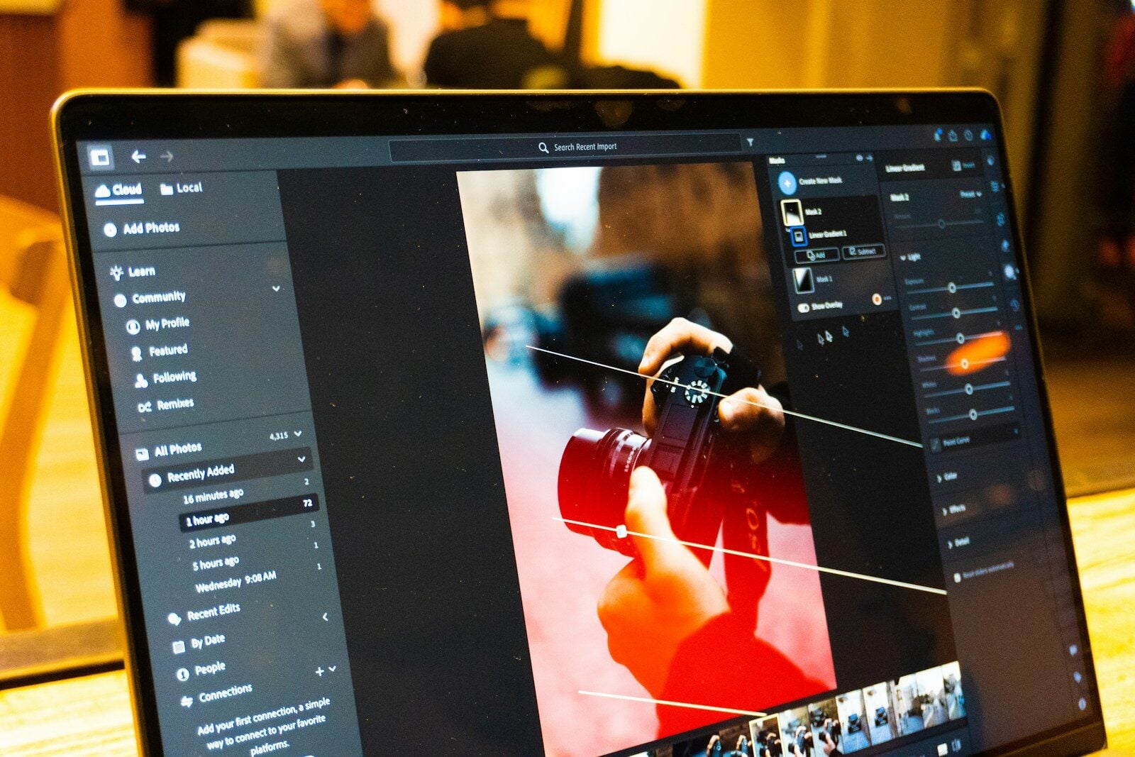 Photo editing software is shown on a laptop screen.