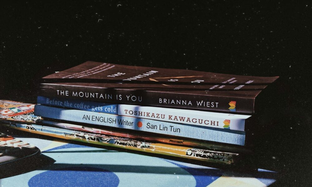 a stack of books sitting on top of a table