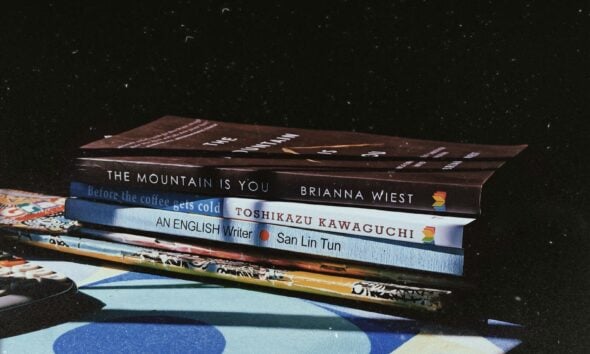 a stack of books sitting on top of a table