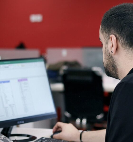 a man sitting in front of a laptop computer