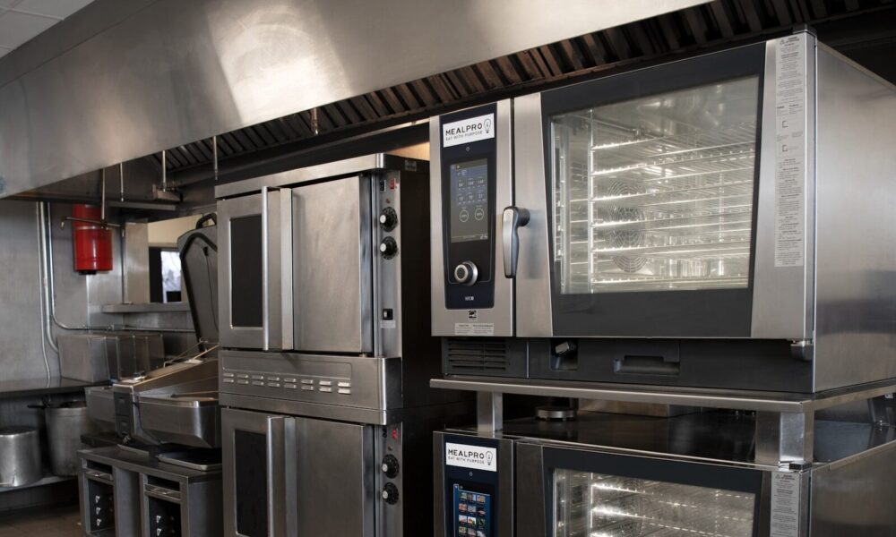 a kitchen filled with lots of stainless steel appliances