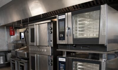 a kitchen filled with lots of stainless steel appliances