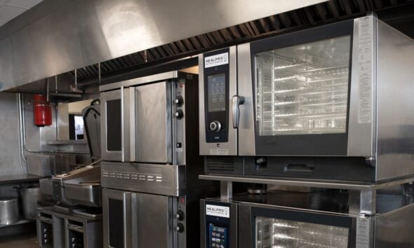 a kitchen filled with lots of stainless steel appliances