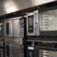 a kitchen filled with lots of stainless steel appliances
