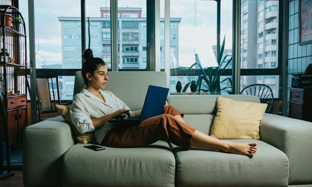 woman in white long sleeve shirt sitting on white couch