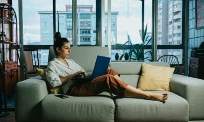 woman in white long sleeve shirt sitting on white couch