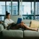 woman in white long sleeve shirt sitting on white couch