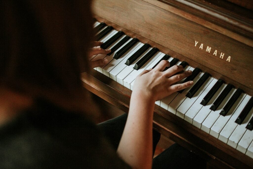 How to Learn Piano Online: The Expert Guide to Fast-Tracking Your Skills 27 woman playing Yamaha piano