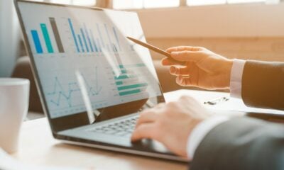 person analyzing business charts on laptop