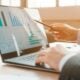 person analyzing business charts on laptop