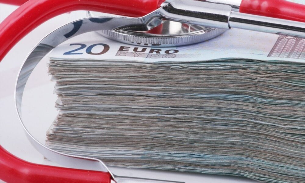 a stethoscope resting on top of a stack of money