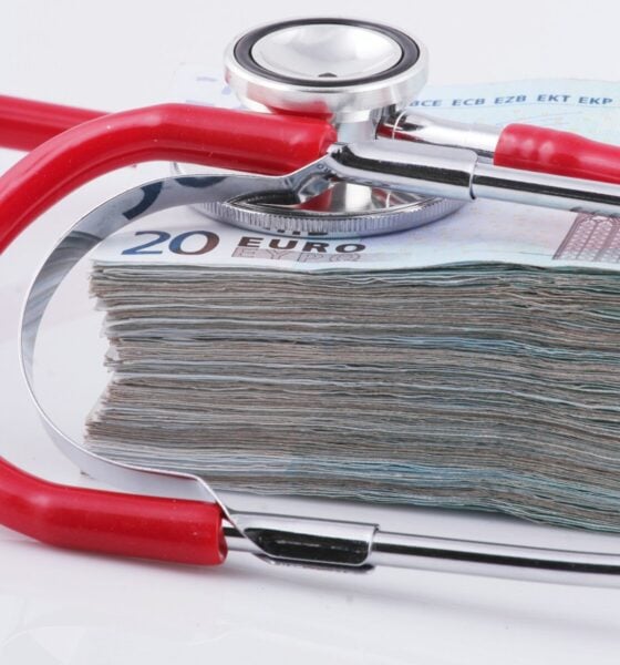 a stethoscope resting on top of a stack of money