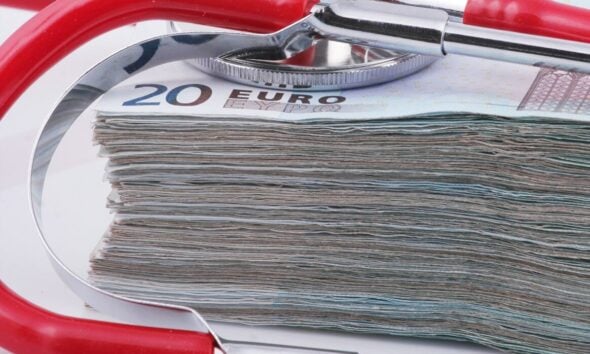 a stethoscope resting on top of a stack of money